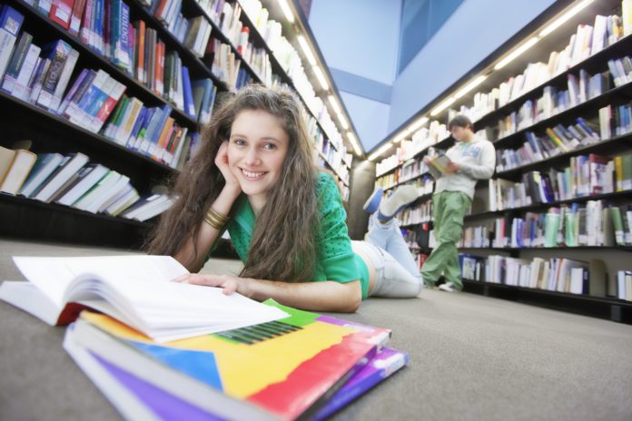 A random Tween enjoys her school library.